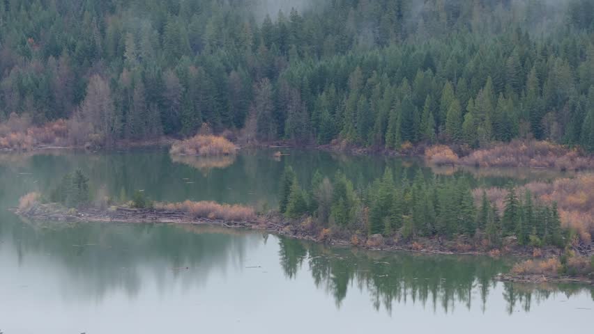 Misty Morning Over a Serene Lake in British Columbia