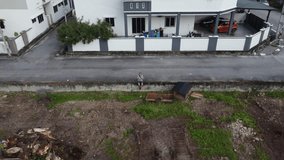 Aerial footage of a man flying drone on the street curb outskirt between farm and the suburban area. - Powered by Shutterstock - Get 15% off with code: PIKWIZARD15