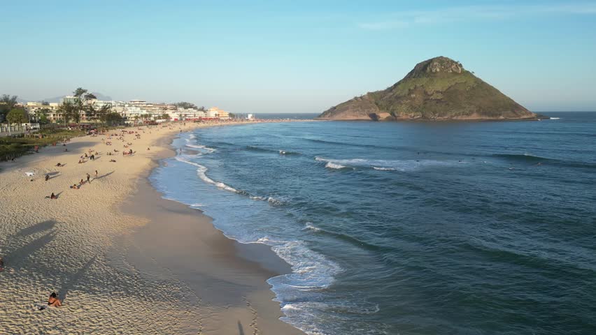 Beautiful image of Macumba beach, Recreio, Rio de Janeiro, Brazil, mountain beach, blue sky, hot day, waves, surfers and bathers.