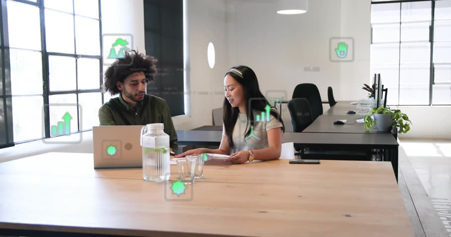Woman flipping papers and showing card to man reviewing report in business review, AR data drifting. Coworkers, teamwork, laptop, documents, openplan, office, modern