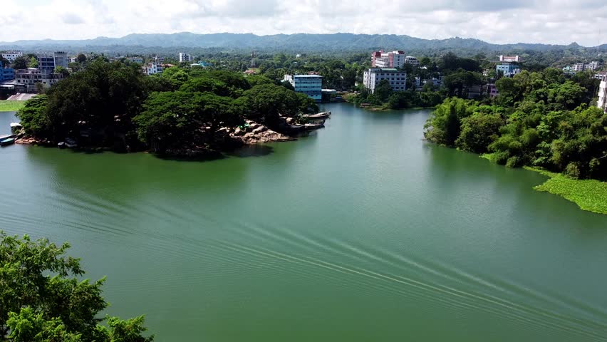 Scenic Lake View with Green Hills and City Buildings in Bangladesh