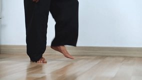 Focused elderly asian man demonstrating martial arts stance with intense gaze - Powered by Shutterstock - Get 15% off with code: PIKWIZARD15