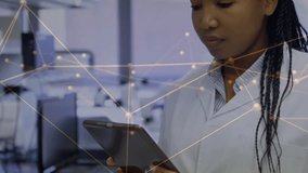 Scientist in lab tapping tablet and animating network overlay across hands while checking data. Researcher, laboratory, display, analytics, visualization, focus, concentration - Powered by Shutterstock - Get 15% off with code: PIKWIZARD15