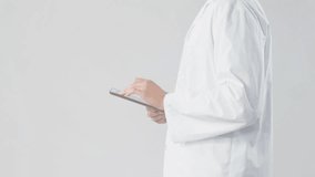 Clinician tapping tablet and activating blue HUD with eye icon, scrolling, reviewing clinical data. Futuristic, interface, studio, medical, technology, circuit, analytics - Powered by Shutterstock - Get 15% off with code: PIKWIZARD15