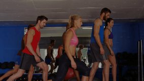 Lead woman cueing, group doing synced lunges for fitness, animated data graphs tracking motion. Workout, teamwork, gym, studio, mirror, dumbbells, stabilityball - Powered by Shutterstock - Get 15% off with code: PIKWIZARD15