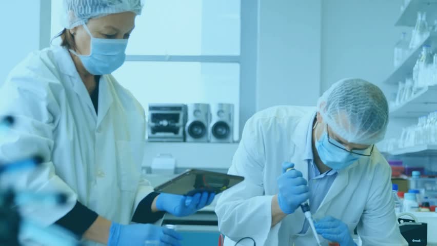 Left lab tech showing tablet and causing 01 sphere growing while male tech pipetting saving data. Laboratory, scientists, collaboration, pipette, tubes, reagents, digital - Powered by Shutterstock - Get 15% off with code: PIKWIZARD15