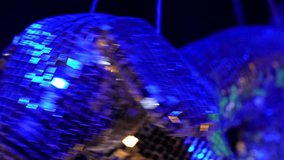 A disco ball in the shape of a dachshund spins on a string and glows brightly with multi-colored flowers during a party or musical performance. - Powered by Shutterstock - Get 15% off with code: PIKWIZARD15