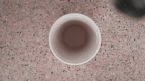 Close-up of white clear liquid pouring from shaker into glass on bar counter - Powered by Shutterstock - Get 15% off with code: PIKWIZARD15