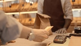 A customer taps a credit card for quick contactless payment as the baker hands over a fresh order.
 - Powered by Shutterstock - Get 15% off with code: PIKWIZARD15