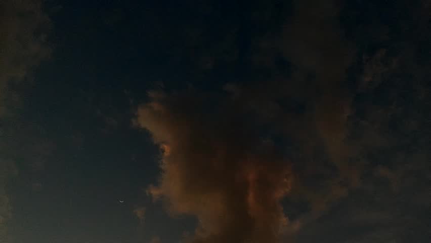 A view of evening clouds illuminated by the setting sun against a backdrop of clear skies above a house in Sumedang, Indonesia