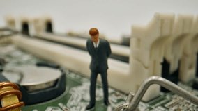Miniature Businessman Figure Standing on an Intricate Green Circuit Board, Carefully Inspecting Electronic Components in a Detailed Macro Close-up Shot, Representing Technology and Problem Solving. - Powered by Shutterstock - Get 15% off with code: PIKWIZARD15