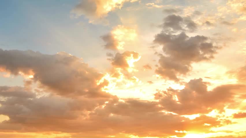 Dramatic sunset sky with vibrant orange and golden clouds creating a peaceful scene