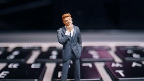 A Miniature Businessman On A Laptop Keyboard Contemplating A Complex Business Problem In A Detailed Macro Close-up Shot. - Powered by Shutterstock - Get 15% off with code: PIKWIZARD15