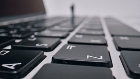 A Miniature Businessman Standing On A Laptop Keyboard, Symbolizing Digital Work And Overwhelm In A Macro Close-up Shot, Real-time Footage. - Powered by Shutterstock - Get 15% off with code: PIKWIZARD15