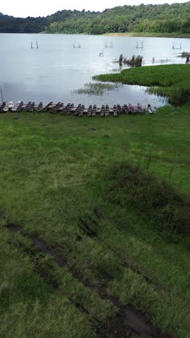 fishing boats docked on the edge of the lake