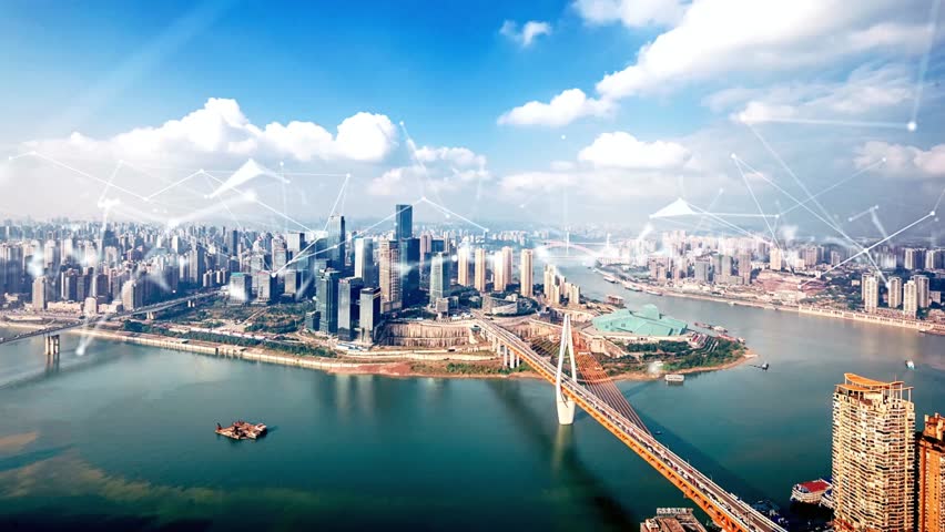 Aerial view of a modern city skyline with a bridge and digital network overlay