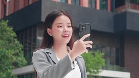 Young asian businesswoman talking and video call with smartphone in urban city, business woman using technology for remote work and communication, online connection or social media and digital career. - Powered by Shutterstock - Get 15% off with code: PIKWIZARD15