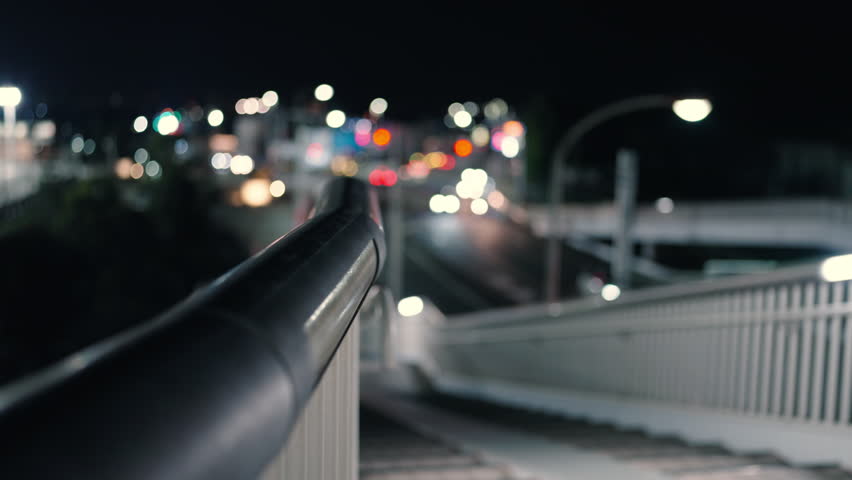 Pedestrian Bridge Stairs with Blurry Night Road