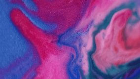 Spilling multicolor emulsion. Flowing paint. Blur blue red orange liquid marble shiny particles water fluid floating on abstract background. - Powered by Shutterstock - Get 15% off with code: PIKWIZARD15