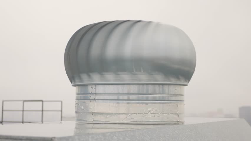 Steel turbine vents on rooftop, Metal ventilation units on city roof top, Closeup of industrial metallic roof vents featuring geometric design and muted gray tones