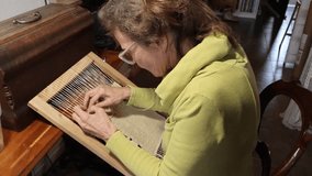 Female artisan weaving a handmade tapestry on a traditional loom in her workshop, Small business concept. High quality 4K video. - Powered by Shutterstock - Get 15% off with code: PIKWIZARD15