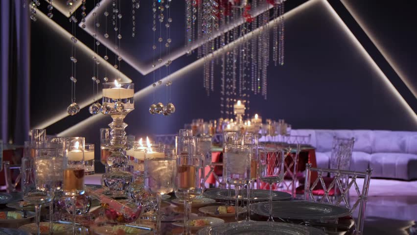 A refined closeup of a luxury restaurant banquet table setup featuring elegant tableware, polished silverware, soft lighting, and a sophisticated dining atmosphere.