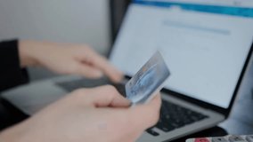 Close-up of female hands entering credit card data to make a purchase or pay bills online, highlighting digital transactions, e-commerce, and secure payment activity. - Powered by Shutterstock - Get 15% off with code: PIKWIZARD15