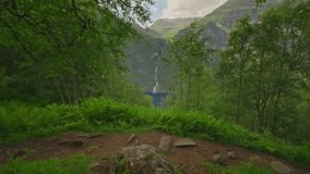 Couple hiking with view of Seven Sisters Waterfall, Geiranger, Norway - Powered by Shutterstock - Get 15% off with code: PIKWIZARD15