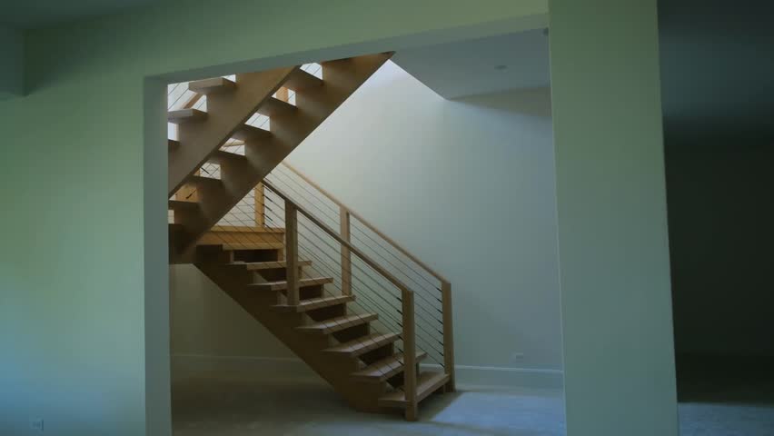 Staircase in the basement of a new house under construction, highlighting modern home development and interior progress.