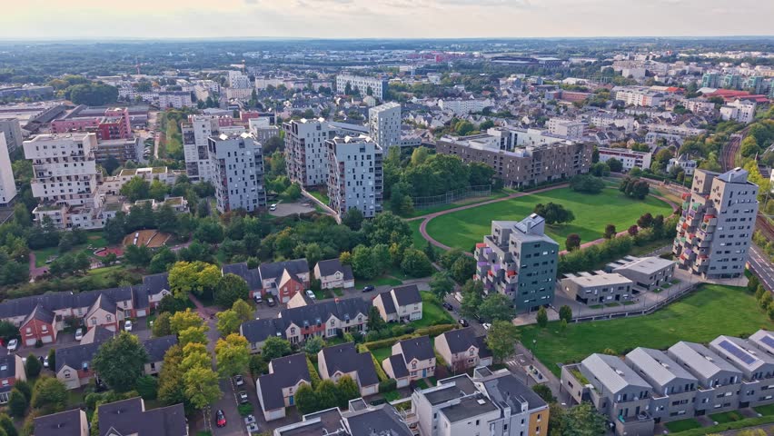 High aerial pan revealing La Courrouze buildings, park and railway in Rennes.