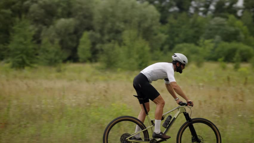 Cyclist Riding On Rural Trail In Field, Athlete Training On Mountain Bike. Summer Outdoor Sport Activity, Fitness And Endurance Cycling. Active Living Recreation. Pedal Power Mountain Biking Cycling