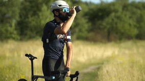 Cyclist Drinking Water From Bottle On Trail. Athlete Taking Hydration Break, Summer Outdoor Sport Activity Fitness Training. Endurance Cycling Rehydrating During Ride. Energy Recovery Sports Equipment - Powered by Shutterstock - Get 15% off with code: PIKWIZARD15