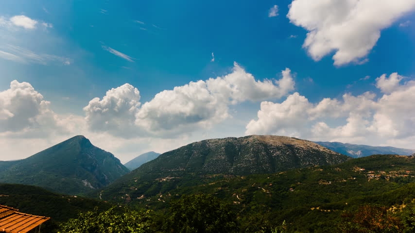 Mountain Range Under Towering Clouds and Blue Sky – 2K 30fps