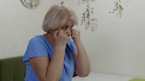 Senior woman engaging in energetic shadow boxing within living room, highlighting physical resilience, fitness dedication, and vibrant approach to healthy aging - Powered by Shutterstock - Get 15% off with code: PIKWIZARD15
