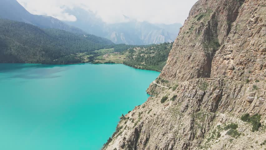 A drone glides above Shey Phoksundo Lake, revealing unreal turquoise water, steep Dolpa cliffs, and untouched Himalayan wilderness. This aerial moment captures Nepal’s remote beauty in pure clarity.