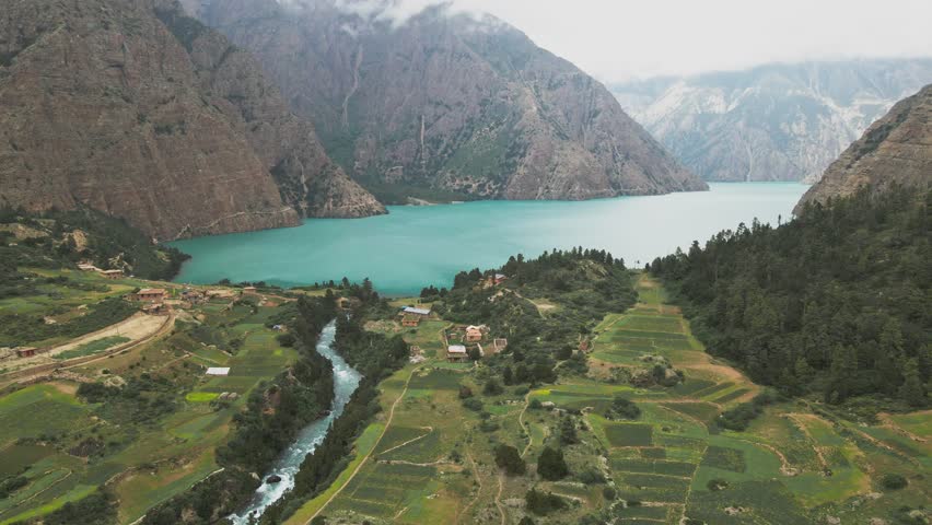 A drone glides above Shey Phoksundo Lake, revealing unreal turquoise water, steep Dolpa cliffs, and untouched Himalayan wilderness. This aerial moment captures Nepal’s remote beauty in pure clarity.