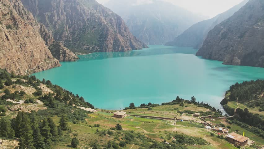 A drone floats over Shey Phoksundo Lake, revealing turquoise depth against Dolpa’s vertical cliffs and vast Himalayan silence. This aerial scene highlights Nepal’s untouched wilderness at its purest.