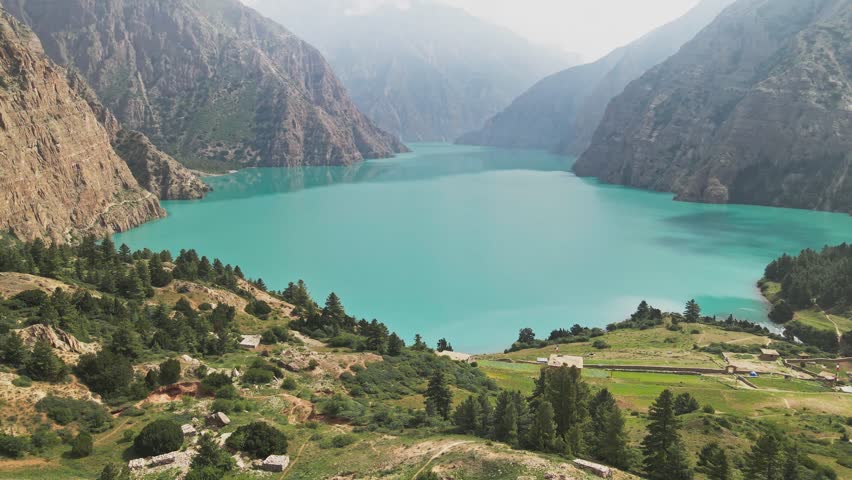A drone floats over Shey Phoksundo Lake, revealing turquoise depth against Dolpa’s vertical cliffs and vast Himalayan silence. This aerial scene highlights Nepal’s untouched wilderness at its purest.