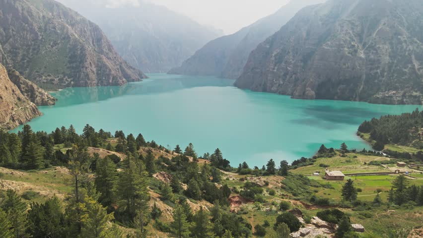 A drone glides above Shey Phoksundo Lake, revealing unreal turquoise water, steep Dolpa cliffs, and untouched Himalayan wilderness. This aerial moment captures Nepal’s remote beauty in pure clarity.