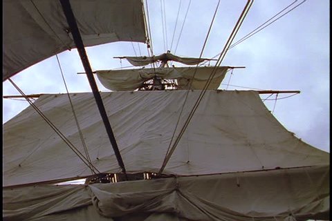Historical reenactment of HMS Bounty ship on Rhode Island. Shots taken on the deck of the HMS Bounty; low angle shot of main mast with unfurled sails.