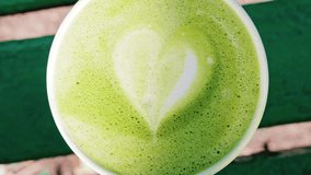 Close up of a frothy matcha latte with heart-shaped latte art - Powered by Shutterstock - Get 15% off with code: PIKWIZARD15