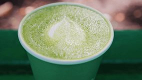 Close up of a frothy matcha latte with heart-shaped latte art - Powered by Shutterstock - Get 15% off with code: PIKWIZARD15