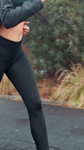 Woman, legs and running with shoes on road for cardio exercise, workout or outdoor training. Active, female person or runner with sprint, speed or motion on asphalt or street for fitness challenge