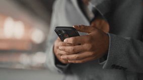 Modern model of smartphone in hands of black man, internet addiction, gadget use . Anonymous internet user messaging in social networks, cybersecurity and cyber criminals, safety in internet site - Powered by Shutterstock - Get 15% off with code: PIKWIZARD15