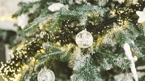 Frosted pine tree branches with clear ornaments and warm string lights sparkling - Powered by Shutterstock - Get 15% off with code: PIKWIZARD15