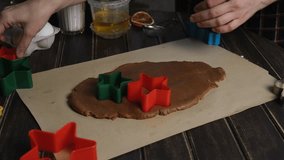 Making Christmas ginger cookies. Female hands using cookie cutters on rolled dough. - Powered by Shutterstock - Get 15% off with code: PIKWIZARD15