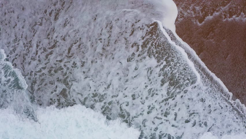 Atlantic ocean waves washing sandy coast at Farol da Nazaré in Nazare, 4K aerial beautyful natural background video