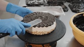 Pastry Chef Spreading Chocolate Ganache On Cake On Turntable. - Powered by Shutterstock - Get 15% off with code: PIKWIZARD15