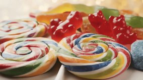 Close-up of a Heap of Colorful Candies, Including Rainbow Lollipops, Gummy Bears, and Jelly Sweets, with a Warm, Blurry Bokeh Background - Powered by Shutterstock - Get 15% off with code: PIKWIZARD15