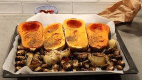 Stockholm, Sweden An oven tray with roasted brussels sprouts, garlic, onions, and butternut squash to make a soup.  - Powered by Shutterstock - Get 15% off with code: PIKWIZARD15